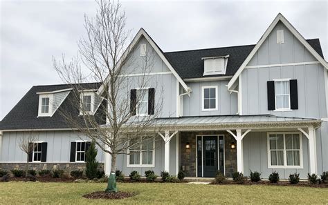 gray metal roof on gray house|black roof with gray siding.